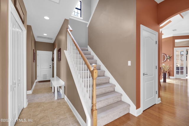 521 S Bridge Creek Dr, Saint Johns, FL 32259 - staircase featuring arched walkways, baseboards, recessed lighting, and a high ceiling