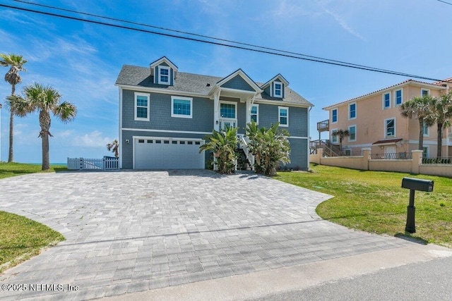 3083 S Ponte Vedra Blvd, Ponte Vedra Beach, FL 32082 - raised beach house featuring decorative driveway, a garage, and a gate