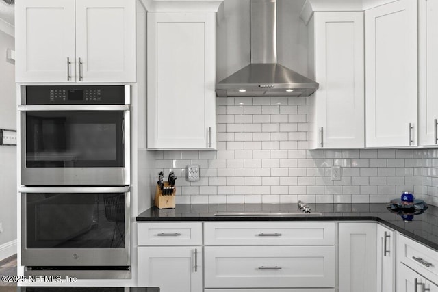 3083 S Ponte Vedra Blvd, Ponte Vedra Beach, FL 32082 - kitchen with double oven, wall chimney range hood, black electric cooktop, white cabinetry, and dark countertops