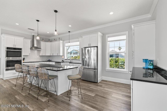 3083 S Ponte Vedra Blvd, Ponte Vedra Beach, FL 32082 - kitchen featuring appliances with stainless steel finishes, a sink, wall chimney exhaust hood, dark countertops, and white cabinetry