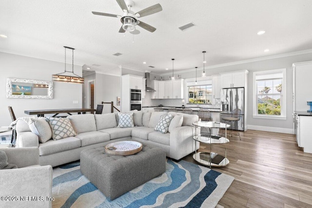3083 S Ponte Vedra Blvd, Ponte Vedra Beach, FL 32082 - living area featuring ornamental molding, light wood-style floors, a ceiling fan, recessed lighting, and baseboards