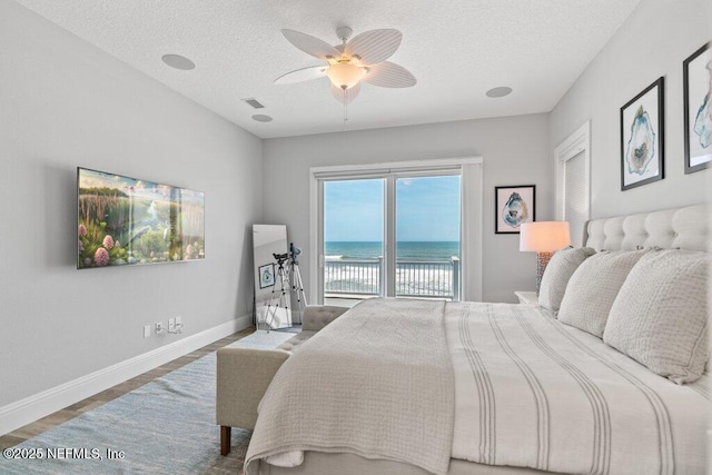 3083 S Ponte Vedra Blvd, Ponte Vedra Beach, FL 32082 - bedroom with access to exterior, a textured ceiling, baseboards, wood finished floors, and a ceiling fan