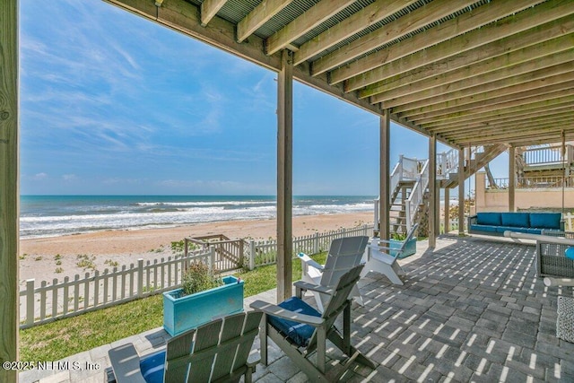 3083 S Ponte Vedra Blvd, Ponte Vedra Beach, FL 32082 - view of patio / terrace with stairway, fence, view of water and beach, and an outdoor living space