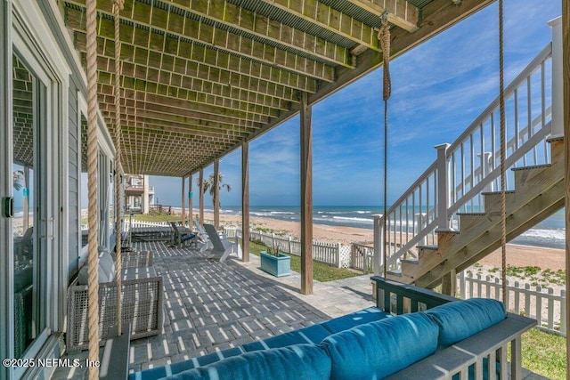 3083 S Ponte Vedra Blvd, Ponte Vedra Beach, FL 32082 - view of patio featuring an outdoor living space, stairs, and view of water and beach