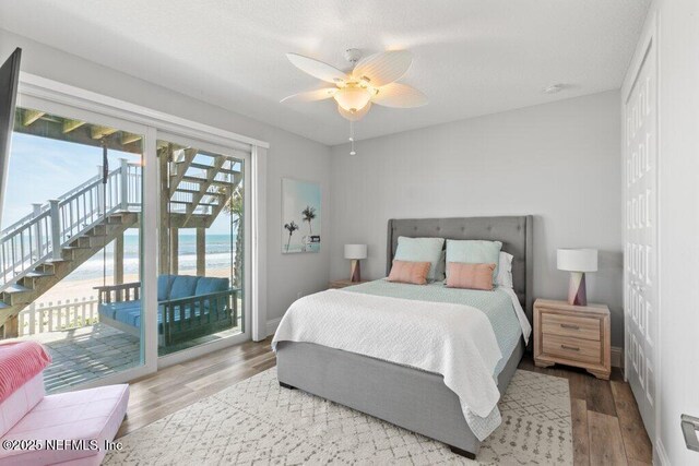 3083 S Ponte Vedra Blvd, Ponte Vedra Beach, FL 32082 - bedroom featuring access to outside, wood finished floors, ceiling fan, a water view, and baseboards
