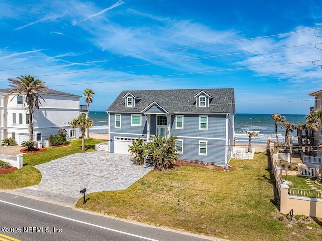 3083 S Ponte Vedra Blvd, Ponte Vedra Beach, FL 32082 - view of front of home with decorative driveway, a garage, and a water view