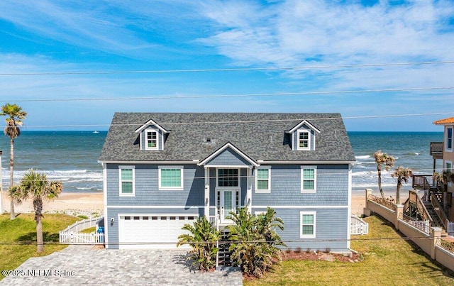 3083 S Ponte Vedra Blvd, Ponte Vedra Beach, FL 32082 - view of front of property featuring decorative driveway, a gate, a water view, fence, and a garage
