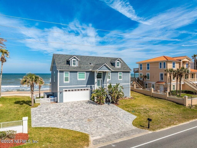 3083 S Ponte Vedra Blvd, Ponte Vedra Beach, FL 32082 - view of front of house with decorative driveway, an attached garage, and a water view