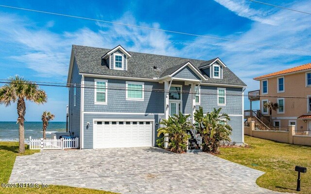 3083 S Ponte Vedra Blvd, Ponte Vedra Beach, FL 32082 - view of front of property with decorative driveway, a water view, and a garage