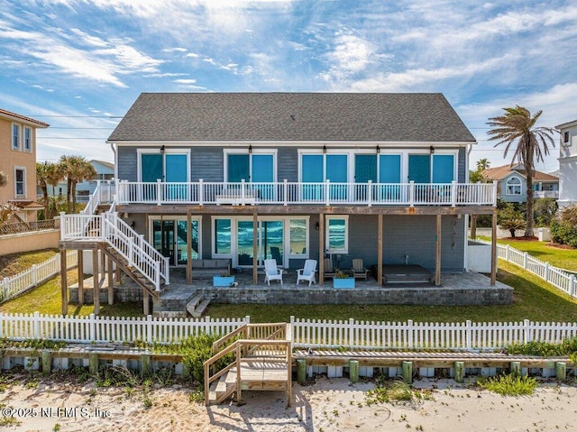 3083 S Ponte Vedra Blvd, Ponte Vedra Beach, FL 32082 - back of property with stairway, a patio area, a fenced backyard, a wooden deck, and an outdoor living space