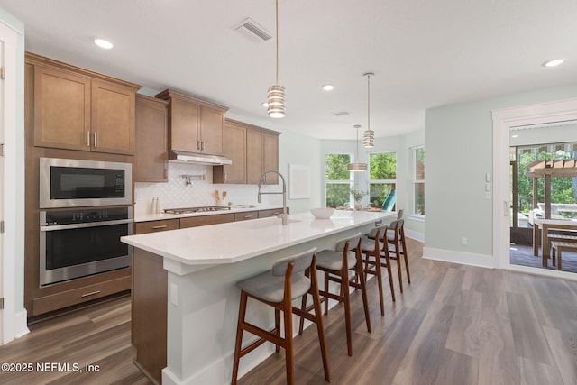 55 Rainbow Trout Ln, Ponte Vedra, FL 32081 - kitchen featuring stainless steel appliances, a sink, dark wood finished floors, under cabinet range hood, and recessed lighting