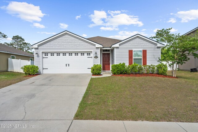 single story home with fence, a garage, driveway, and a front lawn