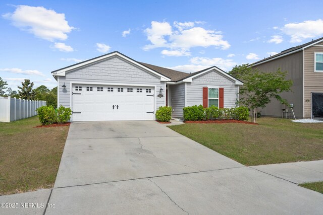 ranch-style house with a garage, fence, a front yard, and concrete driveway