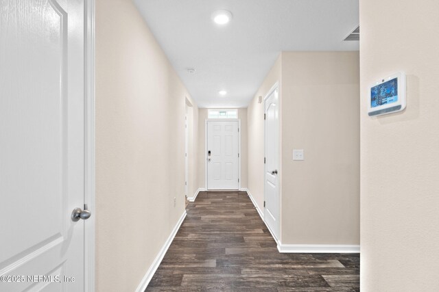 hallway with recessed lighting, baseboards, dark wood-style floors, and visible vents