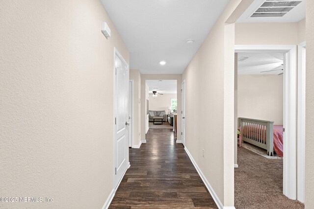 hall featuring recessed lighting, baseboards, visible vents, and dark wood finished floors
