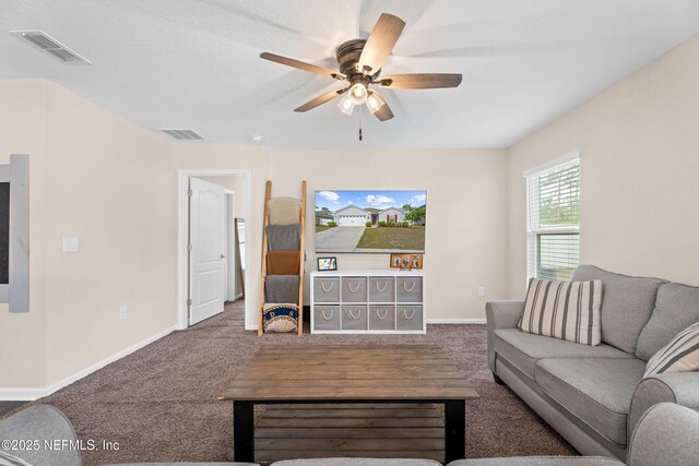 carpeted living area featuring visible vents, a ceiling fan, and baseboards
