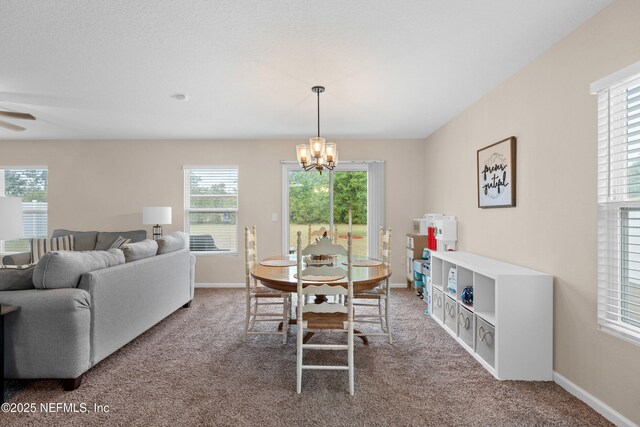 dining room with baseboards, carpet, and ceiling fan with notable chandelier