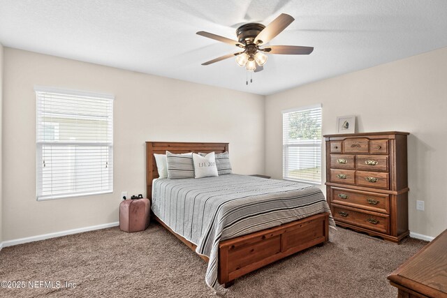 carpeted bedroom featuring a ceiling fan and baseboards