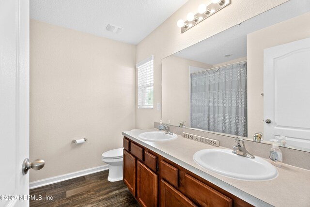 full bath featuring baseboards, a sink, wood finished floors, and toilet