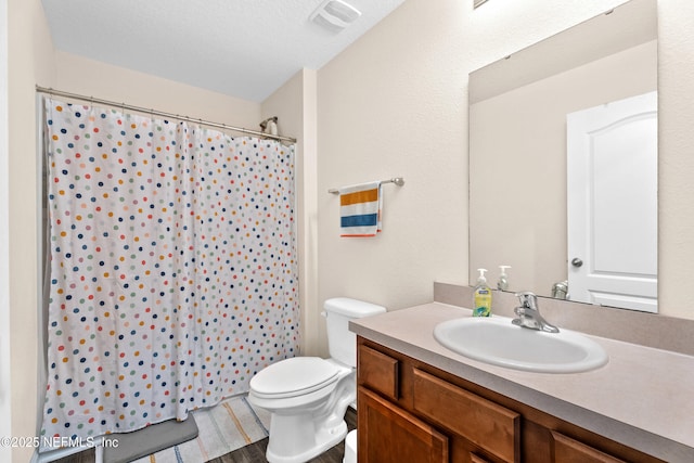 full bathroom featuring vanity, toilet, wood finished floors, curtained shower, and visible vents