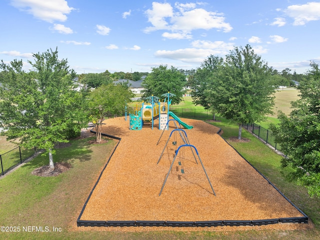 community jungle gym with a lawn and fence