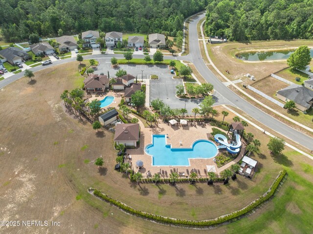 bird's eye view featuring a water view and a wooded view