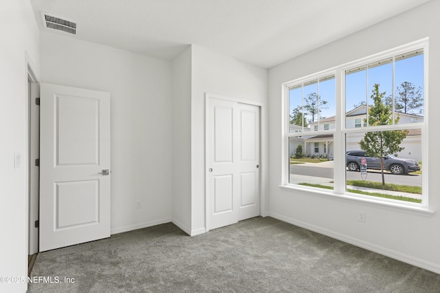 2442 Glade Ln, Green Cove Springs, FL 32043 - unfurnished bedroom with carpet floors, baseboards, and a closet
