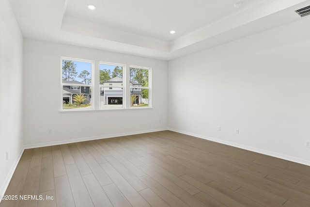 2442 Glade Ln, Green Cove Springs, FL 32043 - unfurnished room featuring a tray ceiling, ornamental molding, dark wood-style flooring, recessed lighting, and baseboards