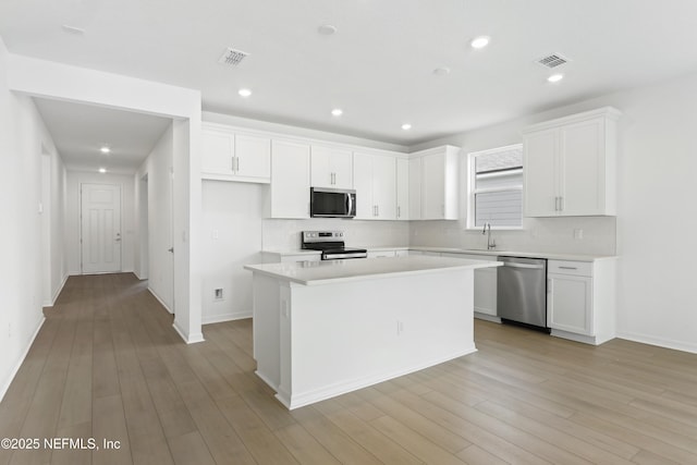 2442 Glade Ln, Green Cove Springs, FL 32043 - kitchen featuring stainless steel appliances, backsplash, white cabinets, light countertops, and recessed lighting