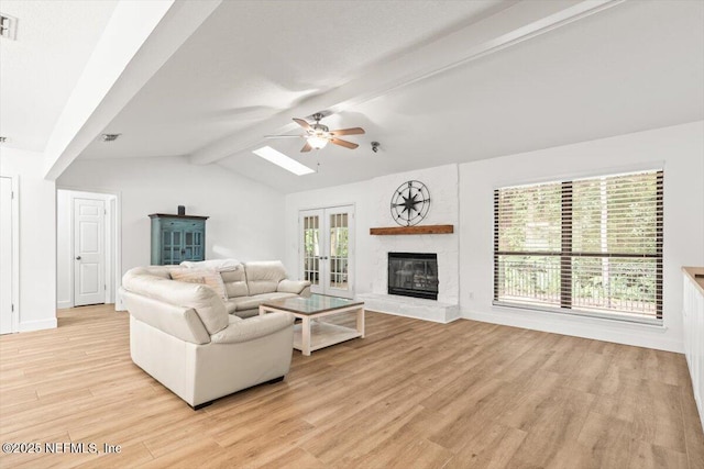 7372 Secret Woods Dr, Jacksonville, FL 32216 - living room featuring ceiling fan, light wood finished floors, a glass covered fireplace, and baseboards