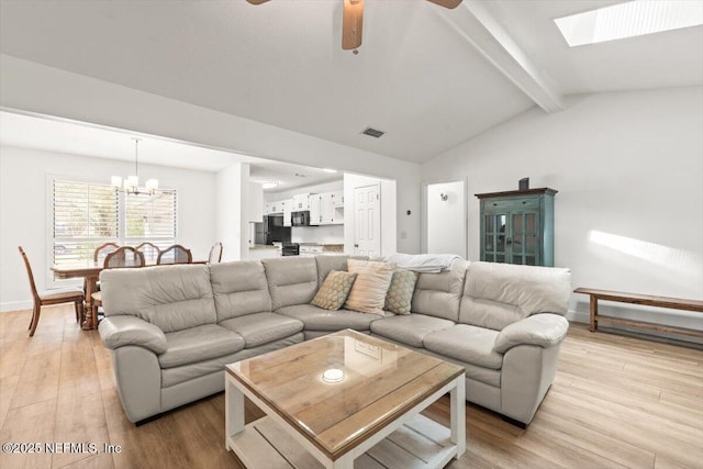 7372 Secret Woods Dr, Jacksonville, FL 32216 - living area with a chandelier, light wood finished floors, a ceiling fan, a skylight, and baseboards