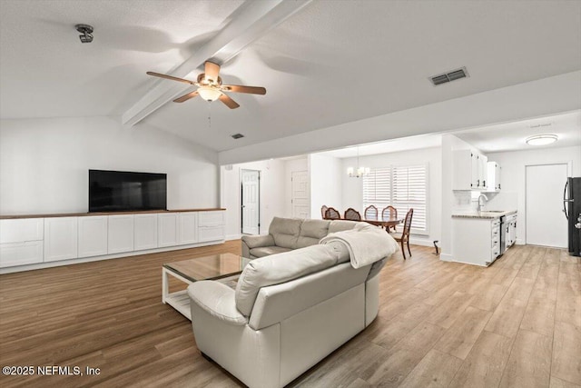 7372 Secret Woods Dr, Jacksonville, FL 32216 - living room featuring a ceiling fan, light wood-style floors, and a chandelier