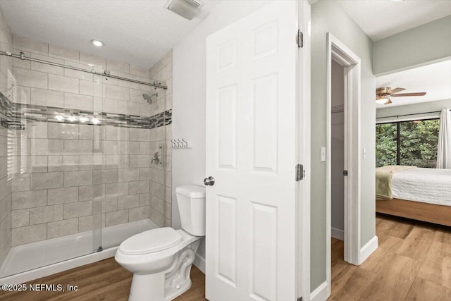 7372 Secret Woods Dr, Jacksonville, FL 32216 - full bathroom featuring a stall shower, toilet, wood finished floors, ceiling fan, and ensuite bathroom