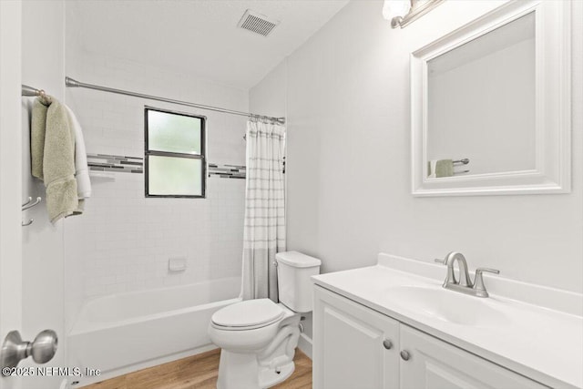 7372 Secret Woods Dr, Jacksonville, FL 32216 - full bath featuring wood finished floors, toilet, vanity, and shower / bath combo with shower curtain