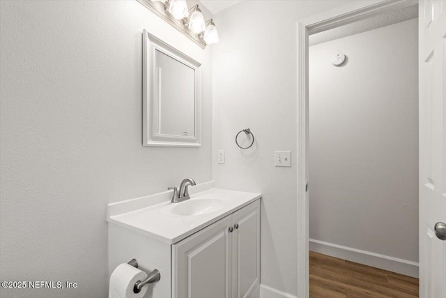 7372 Secret Woods Dr, Jacksonville, FL 32216 - bathroom with vanity, wood finished floors, and baseboards