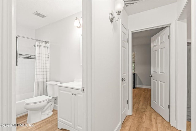 7372 Secret Woods Dr, Jacksonville, FL 32216 - bathroom with wood finished floors, toilet, vanity, and shower / tub combo