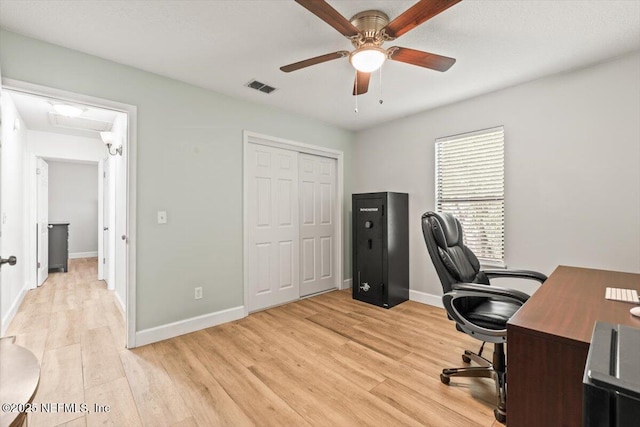7372 Secret Woods Dr, Jacksonville, FL 32216 - home office featuring ceiling fan, light wood-style flooring, and baseboards