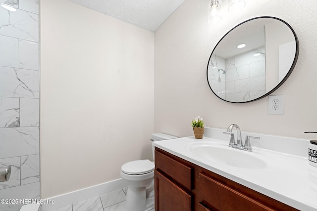 bathroom with a shower, vanity, baseboards, toilet, and marble finish floor