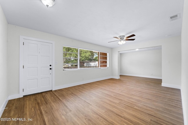 entryway featuring a ceiling fan, baseboards, visible vents, and wood finished floors