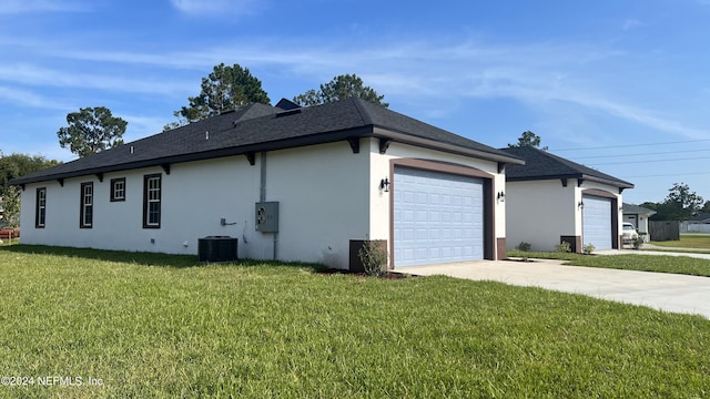 1 Wheel Pl, Palm Coast, FL 32164 - view of side of home featuring central AC, a garage, stucco siding, concrete driveway, and a lawn