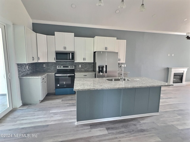 1 Wheel Pl, Palm Coast, FL 32164 - kitchen with stainless steel appliances, ornamental molding, a sink, and tasteful backsplash