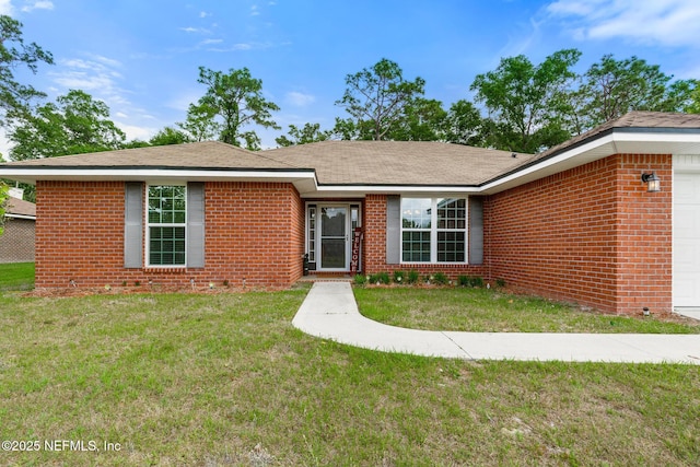 ranch-style home featuring a garage, a front lawn, and brick siding