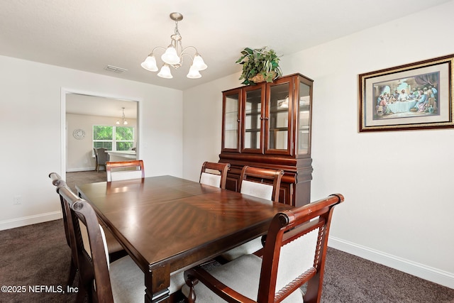 dining area featuring visible vents, baseboards, dark carpet, and a chandelier