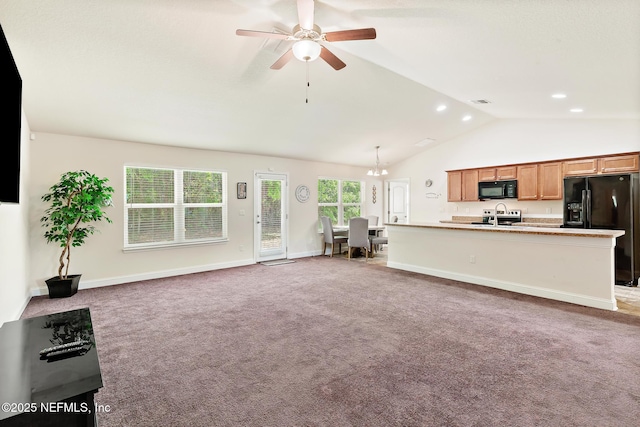 unfurnished living room featuring a ceiling fan, a sink, baseboards, high vaulted ceiling, and light carpet