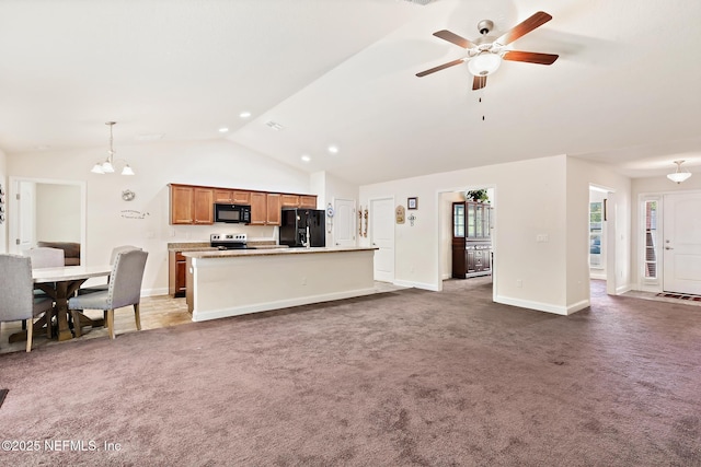 carpeted living area featuring baseboards, ceiling fan with notable chandelier, and vaulted ceiling