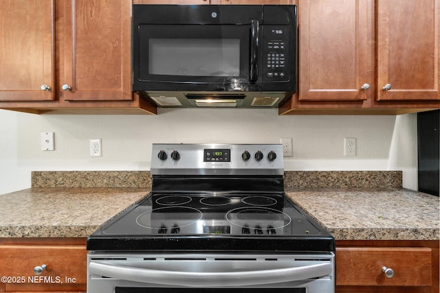 kitchen with light countertops, brown cabinets, black microwave, and stainless steel electric range oven