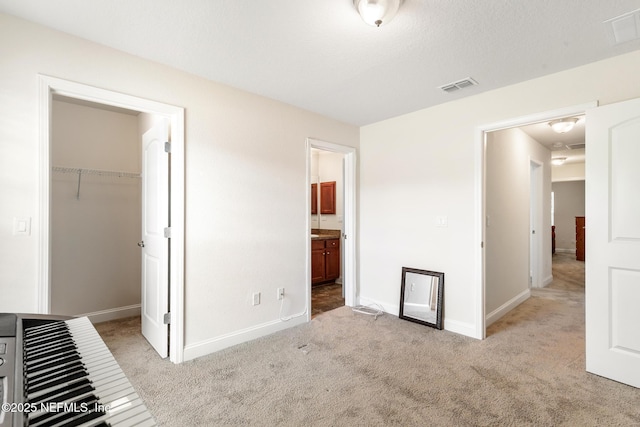 unfurnished bedroom featuring carpet flooring, baseboards, and visible vents