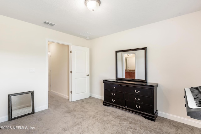 unfurnished bedroom with carpet floors, baseboards, and visible vents