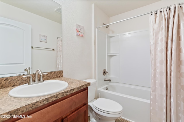 bathroom with toilet, shower / tub combo, and vanity