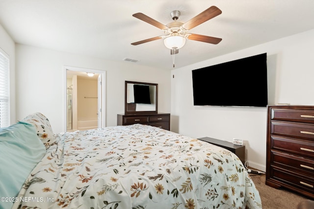 bedroom featuring carpet floors, visible vents, baseboards, connected bathroom, and a ceiling fan
